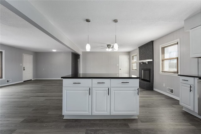 kitchen featuring hanging light fixtures, dark hardwood / wood-style floors, and white cabinets