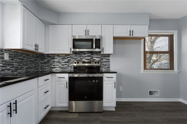 kitchen with dark hardwood / wood-style flooring, decorative backsplash, stainless steel appliances, and white cabinets