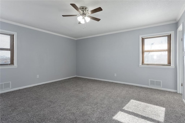 carpeted spare room featuring crown molding, plenty of natural light, and ceiling fan