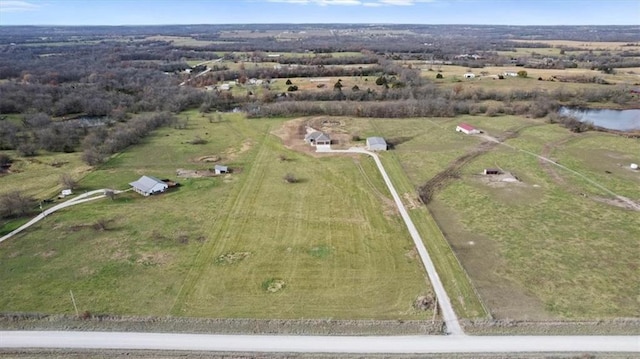 birds eye view of property with a rural view and a water view