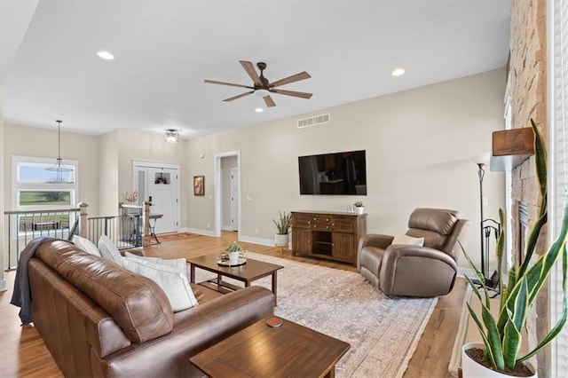 living room featuring ceiling fan and light hardwood / wood-style flooring