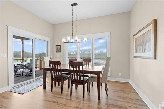 dining area featuring a chandelier and light hardwood / wood-style floors