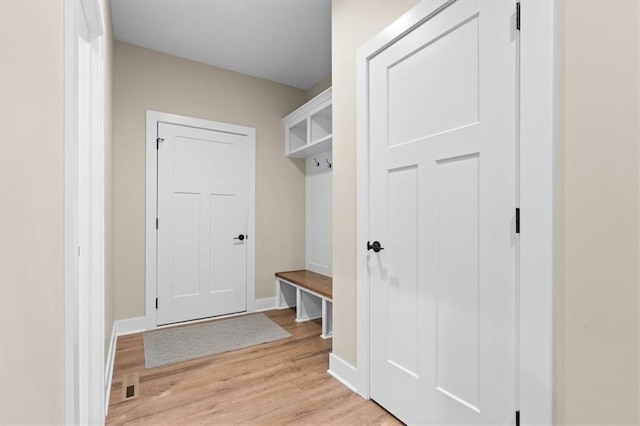 mudroom with light hardwood / wood-style floors