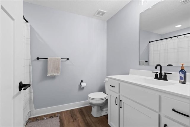 bathroom featuring hardwood / wood-style floors, vanity, and toilet