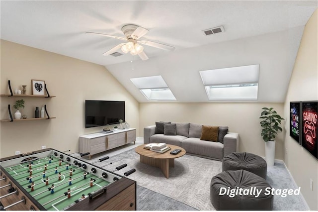 living area featuring lofted ceiling, baseboards, visible vents, and a ceiling fan