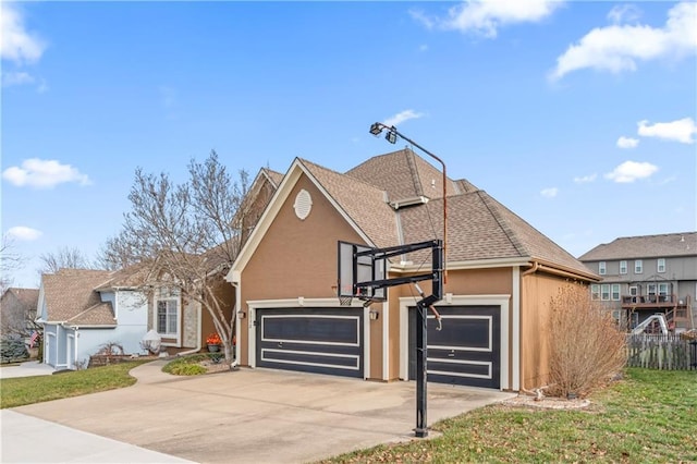 view of front of home featuring roof with shingles, stucco siding, concrete driveway, an attached garage, and a front lawn