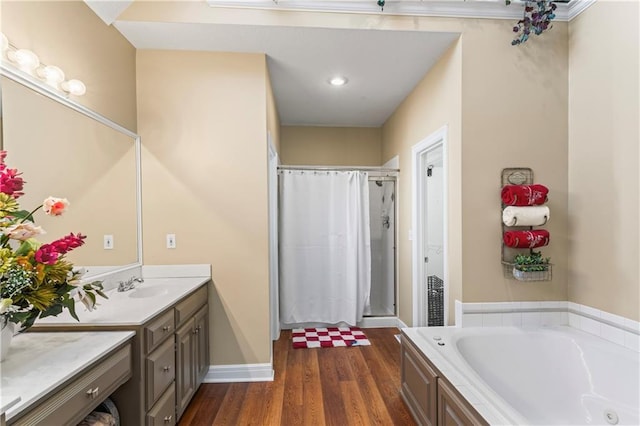 full bath with a garden tub, a shower stall, vanity, and wood finished floors