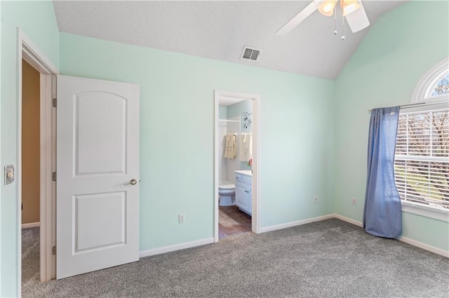 unfurnished bedroom featuring visible vents, vaulted ceiling, light carpet, and baseboards