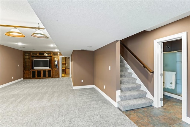 interior space with stairway, carpet, a textured ceiling, and baseboards