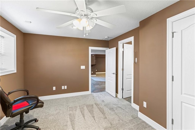 interior space with light carpet, ceiling fan, and baseboards