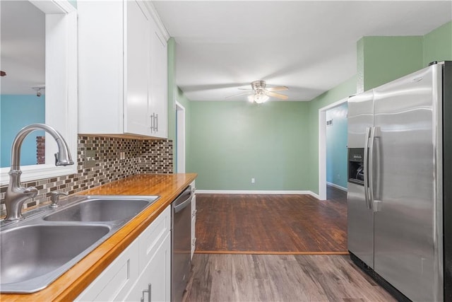 kitchen featuring white cabinets, sink, and appliances with stainless steel finishes