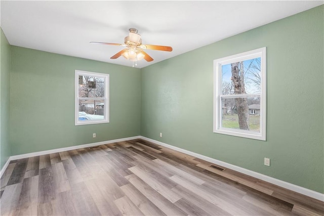 spare room featuring ceiling fan and light hardwood / wood-style floors