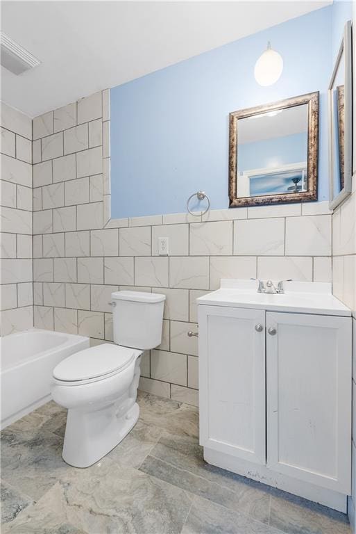 full bathroom with vanity, shower / bathtub combination, toilet, and tile walls