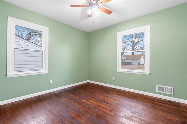 spare room featuring ceiling fan and dark hardwood / wood-style floors