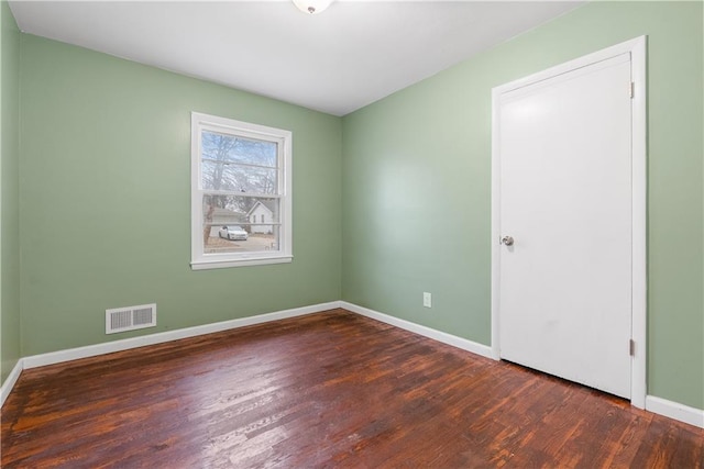 spare room featuring dark hardwood / wood-style flooring