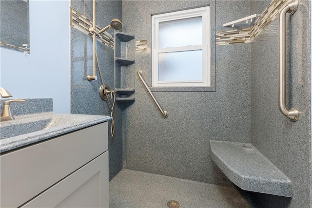 bathroom with vanity, toilet, and tiled shower