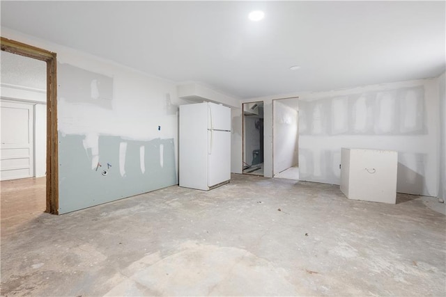 unfurnished bedroom featuring white fridge