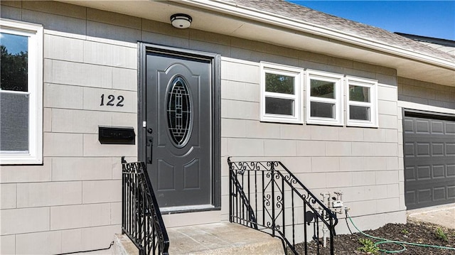 doorway to property featuring a garage