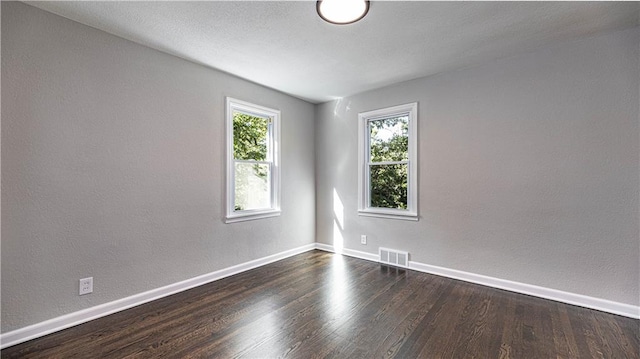 spare room featuring dark hardwood / wood-style floors