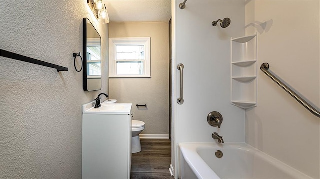 full bathroom featuring hardwood / wood-style flooring, shower / washtub combination, vanity, and toilet