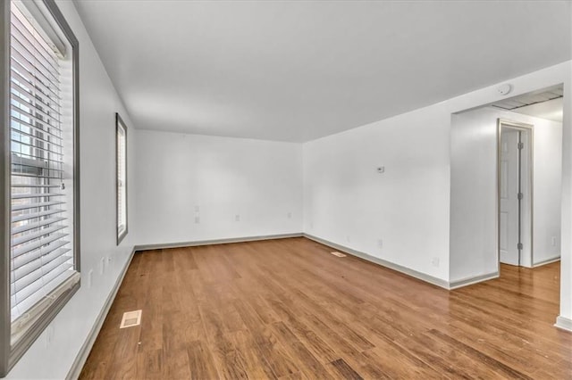 unfurnished room with light wood-type flooring