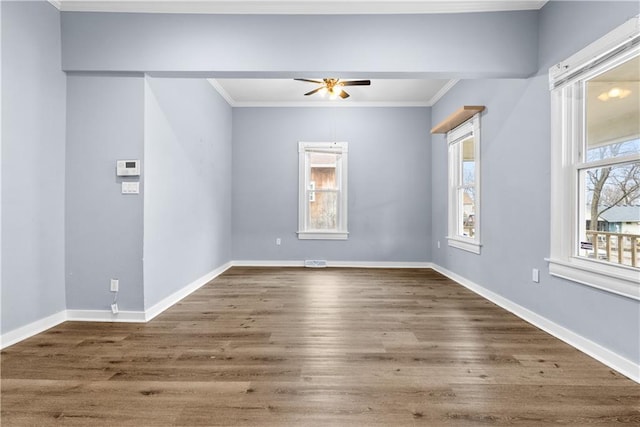 spare room with ceiling fan, ornamental molding, and dark wood-type flooring