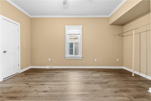 interior space with hardwood / wood-style flooring and ornamental molding