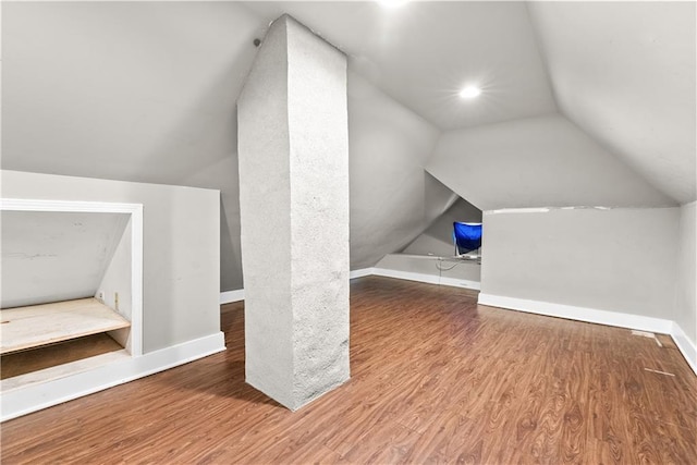 bonus room featuring wood-type flooring and vaulted ceiling