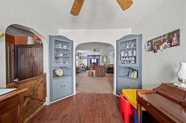 corridor featuring built in features and dark wood-type flooring