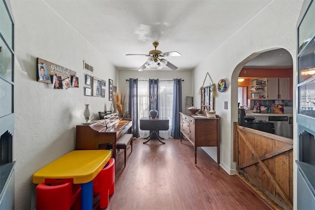 interior space with ceiling fan and dark wood-type flooring