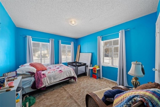 bedroom featuring light carpet and a textured ceiling