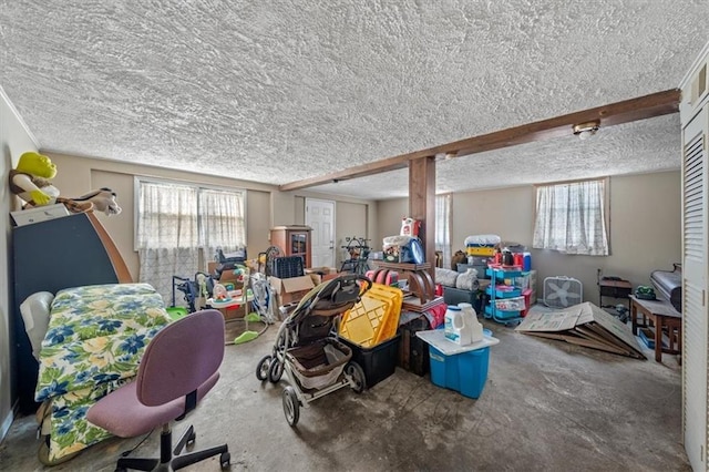 miscellaneous room featuring beam ceiling and a textured ceiling