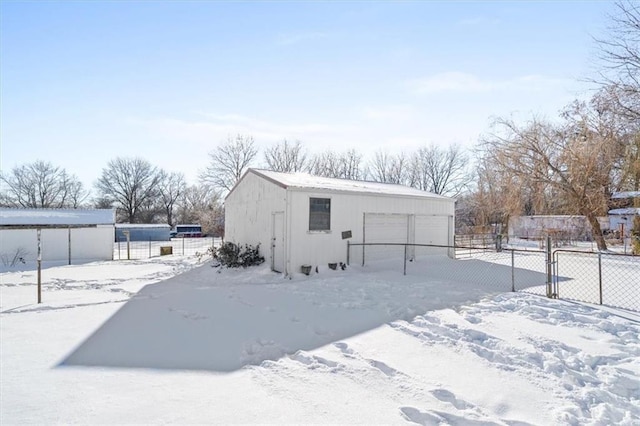 snow covered structure with a garage