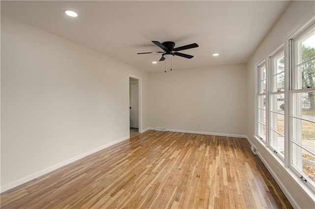 empty room with ceiling fan and light wood-type flooring