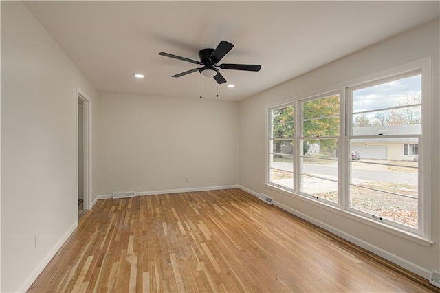 unfurnished room with ceiling fan and light hardwood / wood-style floors