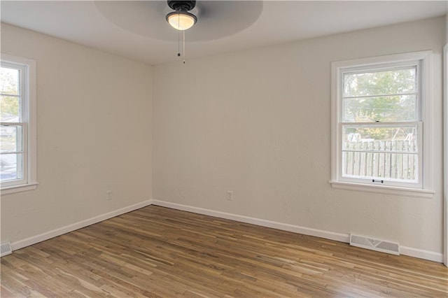 unfurnished room with hardwood / wood-style flooring and ceiling fan