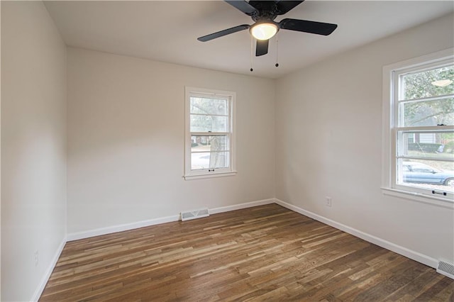 spare room with ceiling fan, dark hardwood / wood-style flooring, and a healthy amount of sunlight