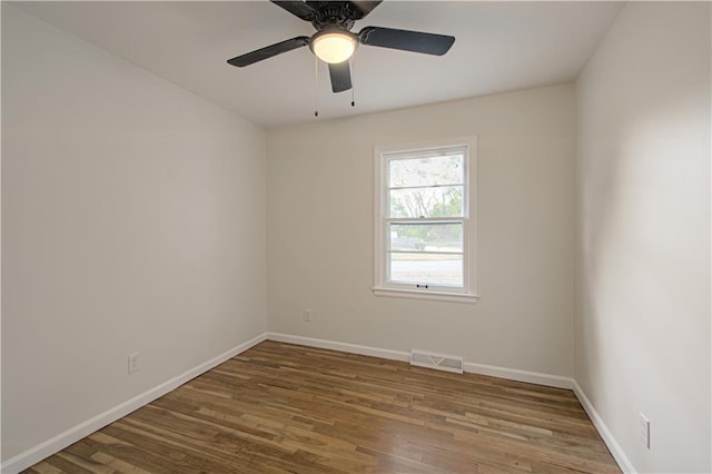 empty room featuring hardwood / wood-style floors and ceiling fan