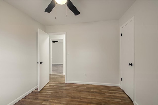 spare room with ceiling fan and dark hardwood / wood-style floors