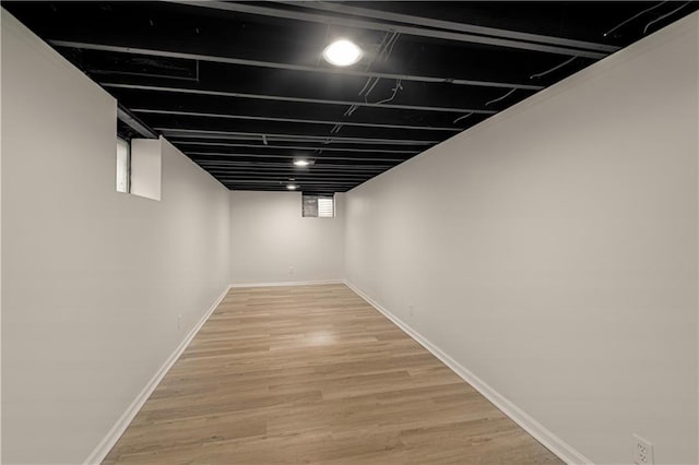 basement featuring wood-type flooring