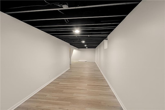 corridor with light hardwood / wood-style floors