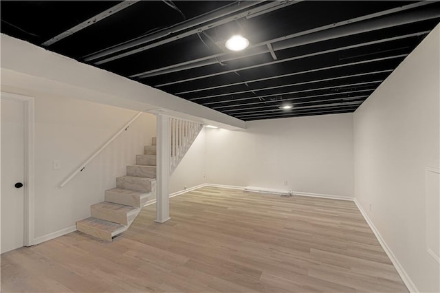 basement with light hardwood / wood-style floors