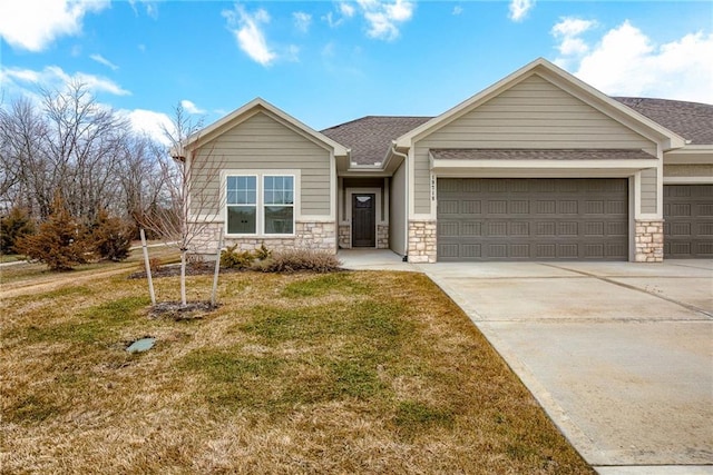 view of front of property with a garage and a front lawn