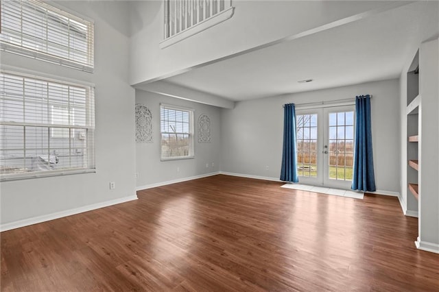 interior space with french doors, a wealth of natural light, and wood-type flooring