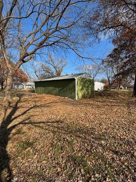 view of property exterior with an outdoor structure