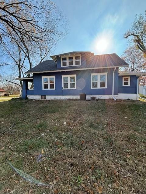 back of house with a lawn