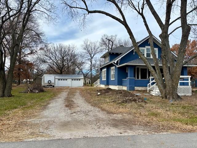 view of side of property featuring covered porch