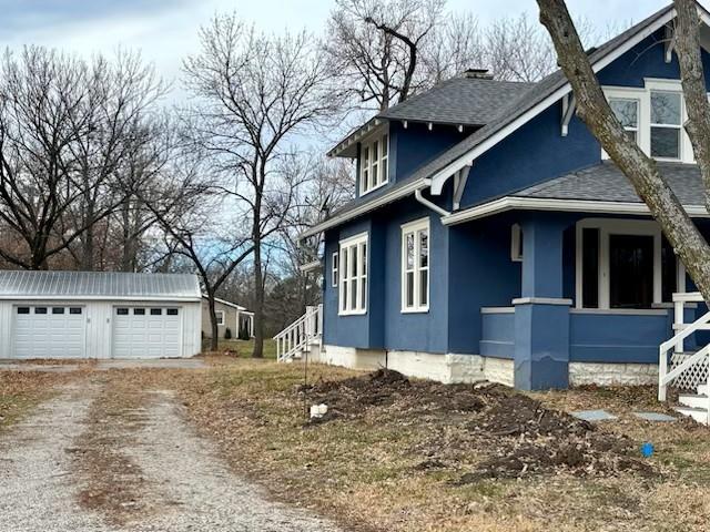 view of property exterior with an outbuilding and a garage