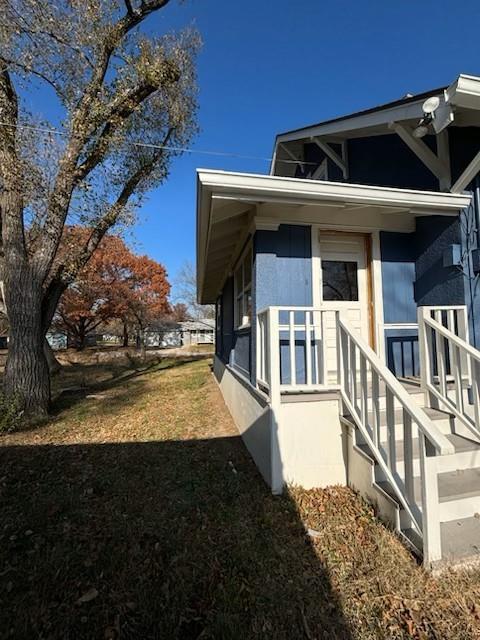 view of side of property featuring a yard