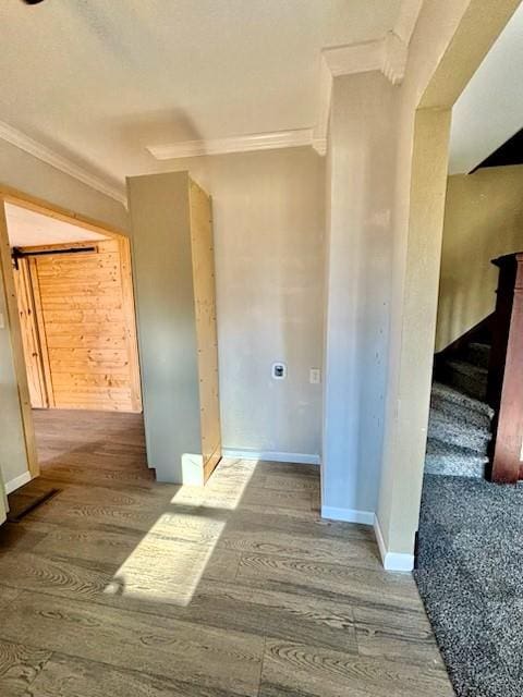 interior space with hardwood / wood-style floors and ornamental molding